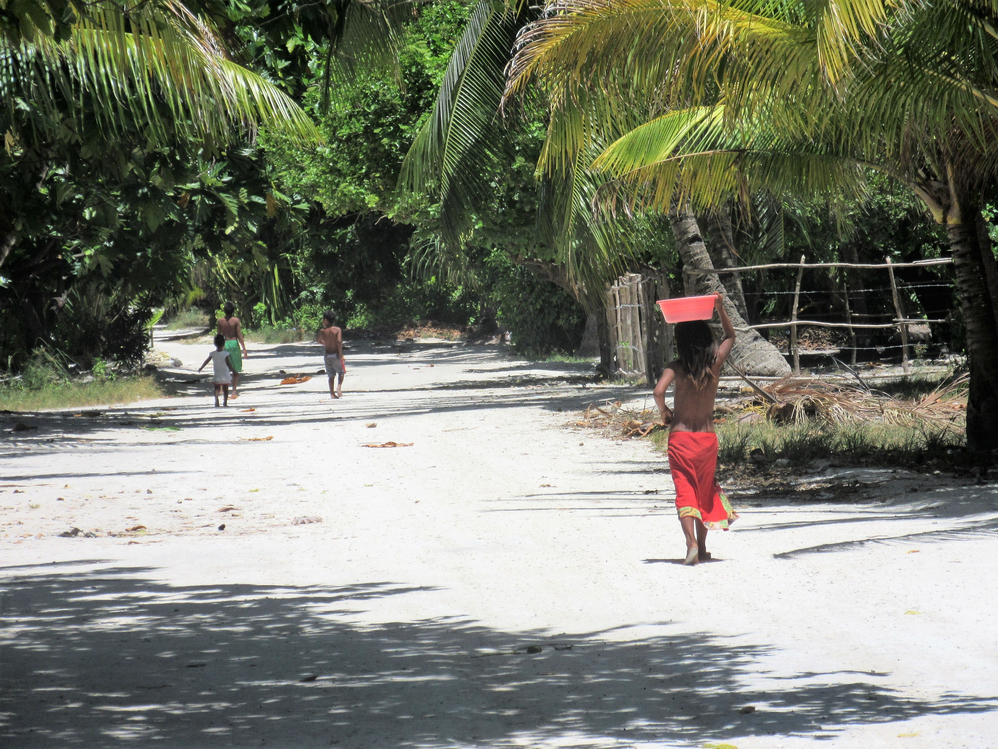 Chirldren in Kiribati walking in the village